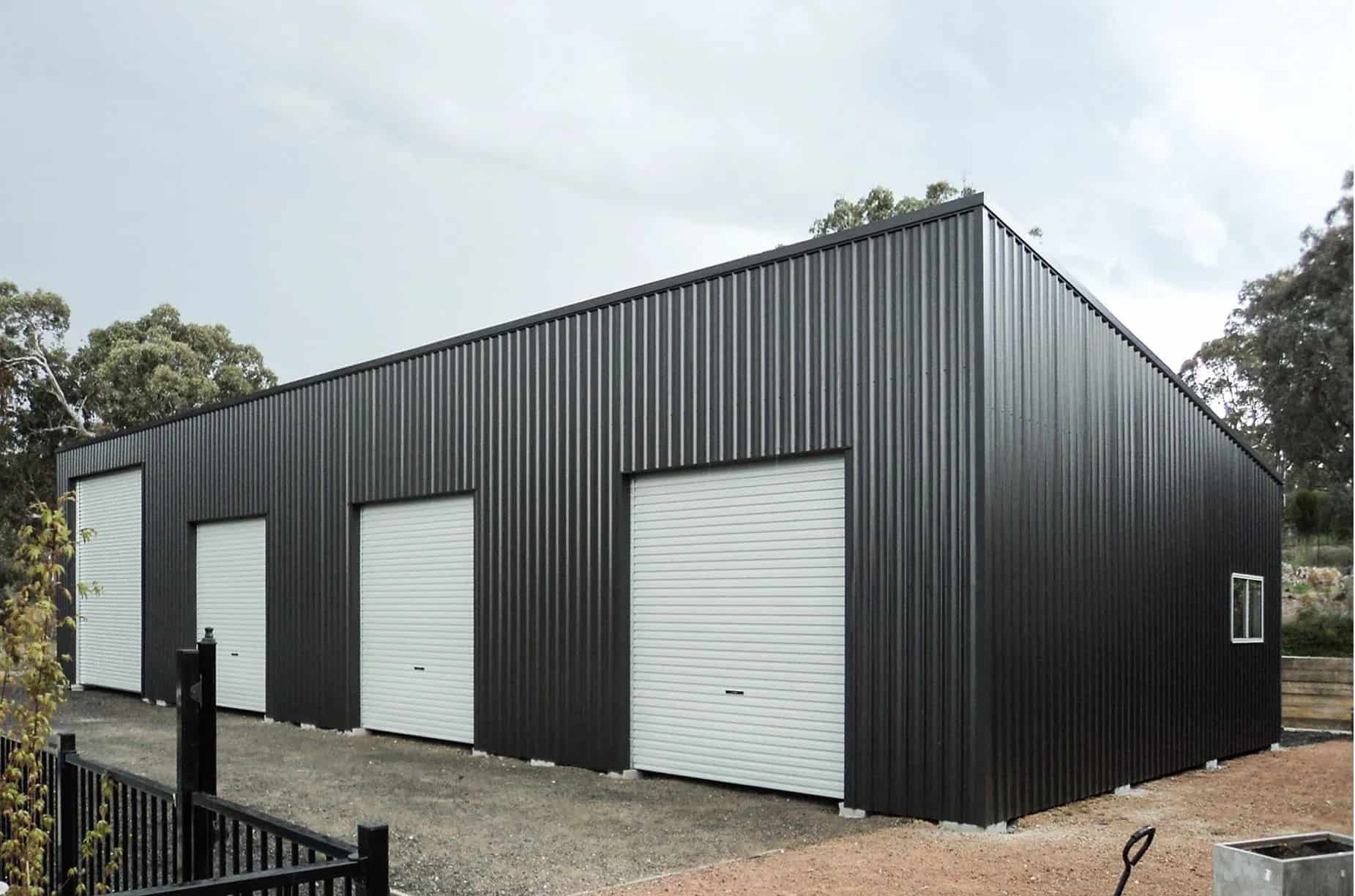 A Close Up Of A Grey Shed With A White Door — Clearspan Builders In Queanbeyan East, NSW
