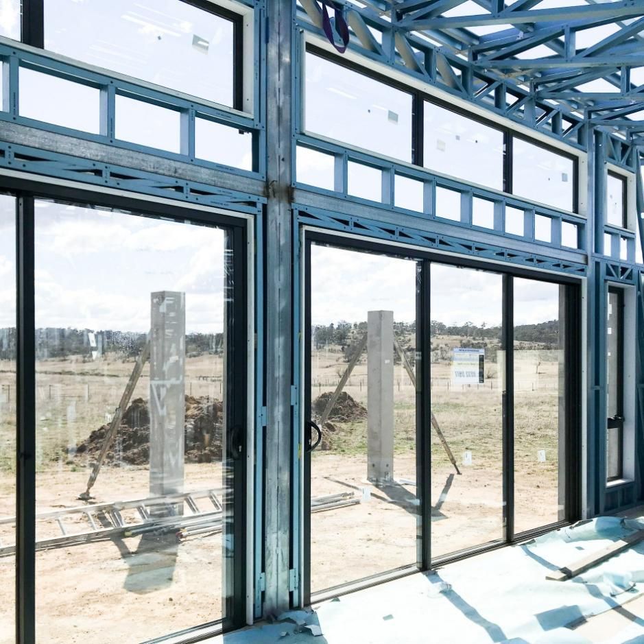 Building Under Construction with Lots of Windows and Sliding Glass Doors — Clearspan Builders In Queanbeyan East, NSW