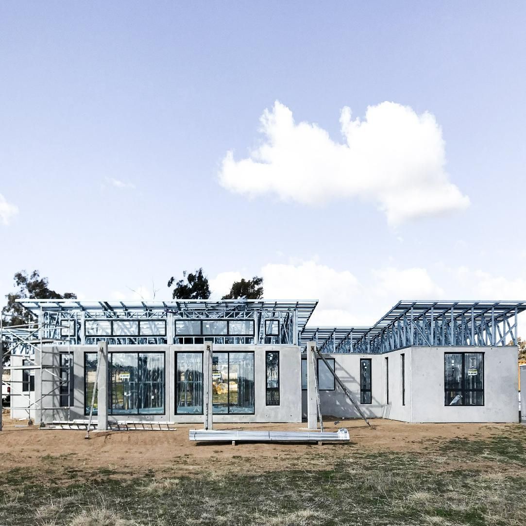House Is Being Built in A Field with A Blue Sky in The Background — Clearspan Builders In Queanbeyan East, NSW
