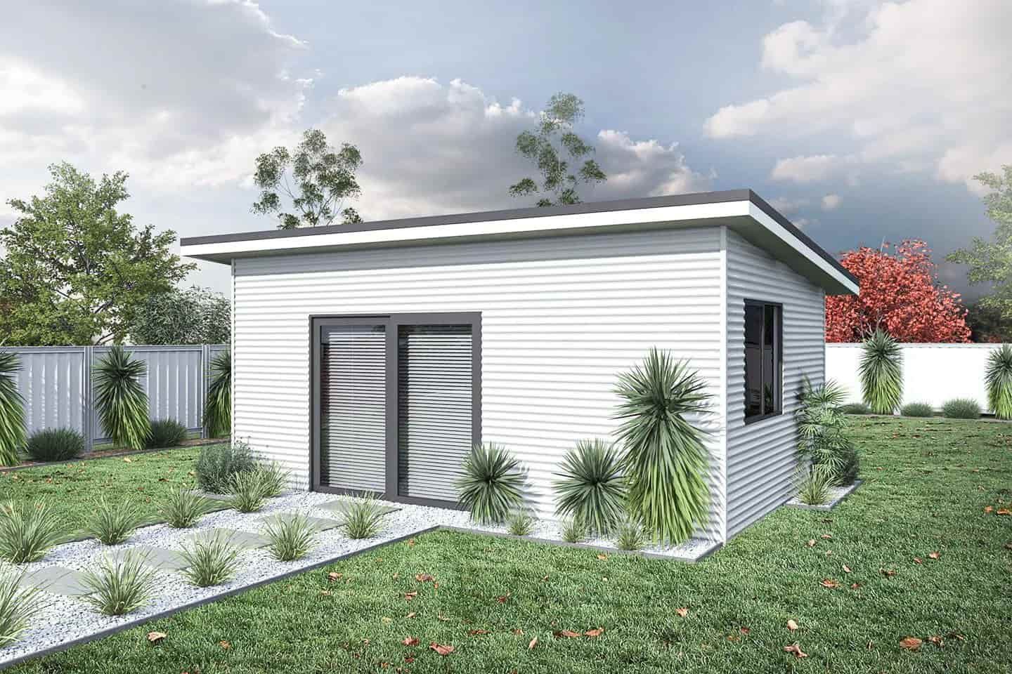 A Tiny White House On A Grassy Field With Green Plants Around It — Clearspan Builders In Queanbeyan East, NSW