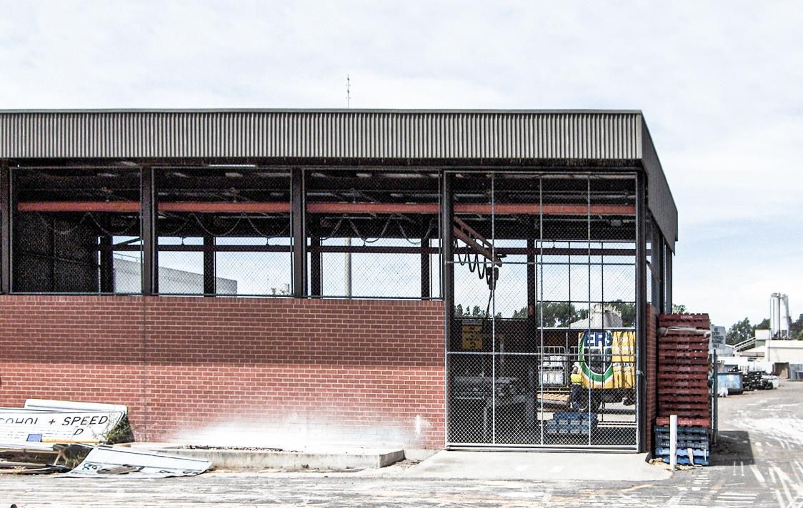 A Large Brick Building Is Being Built in A Parking Lot — Clearspan Builders In Queanbeyan East, NSW
