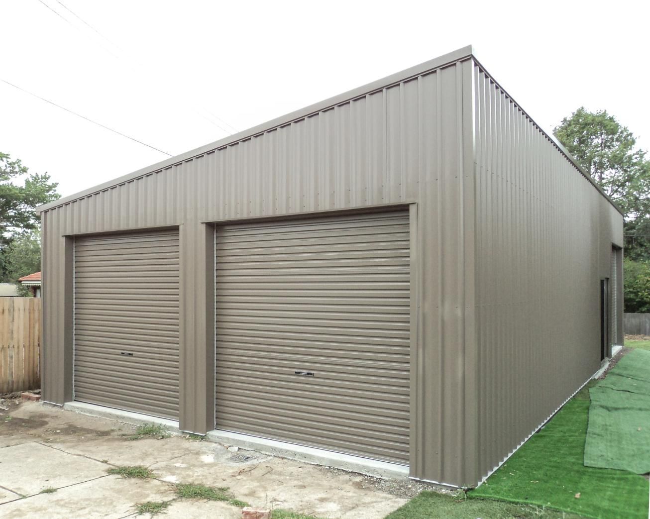 A Garage with Two Garage Doors and A Fence in The Background — Clearspan Builders In Queanbeyan East, NSW