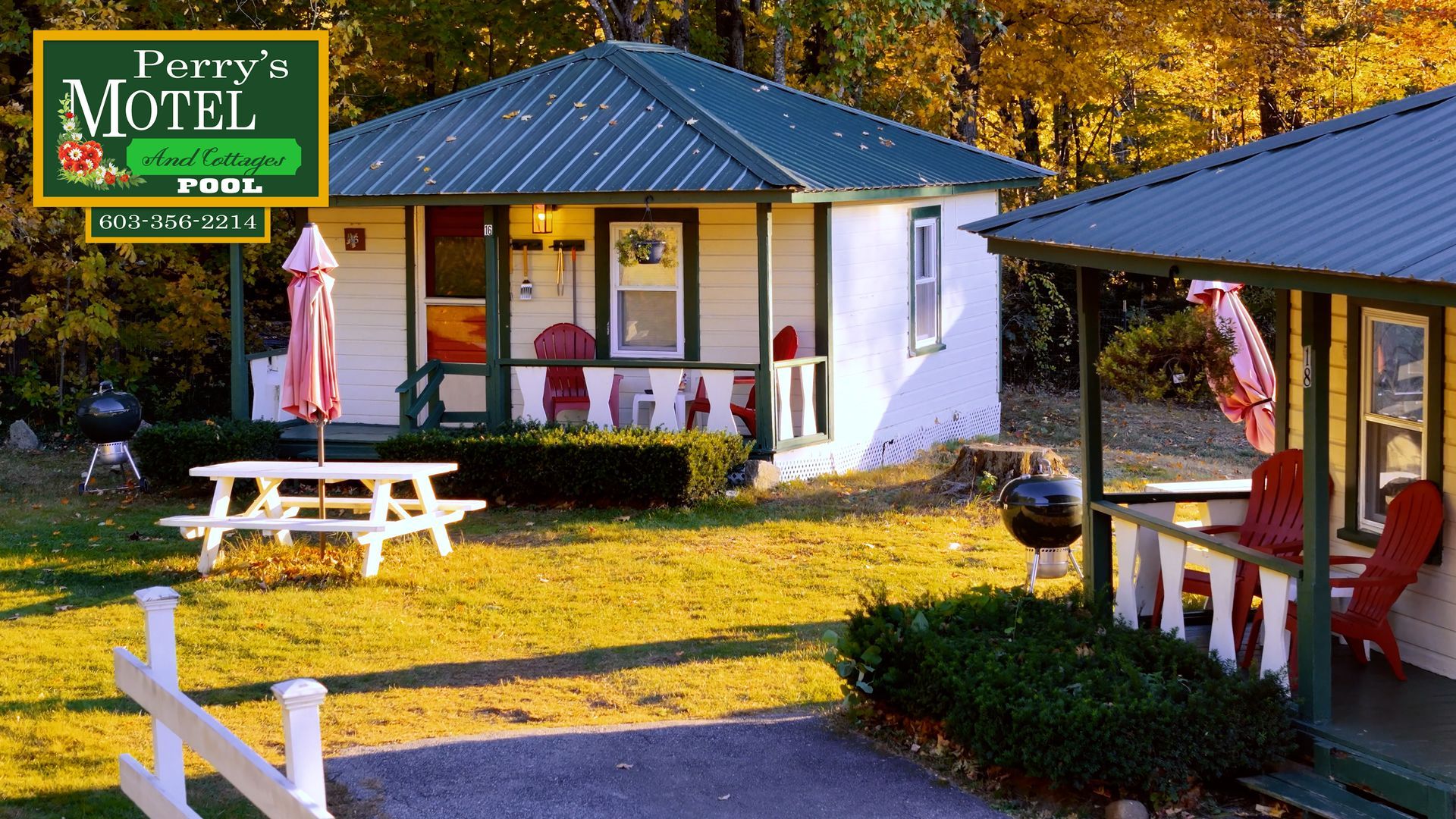 A sign for perry 's motel is above a white house