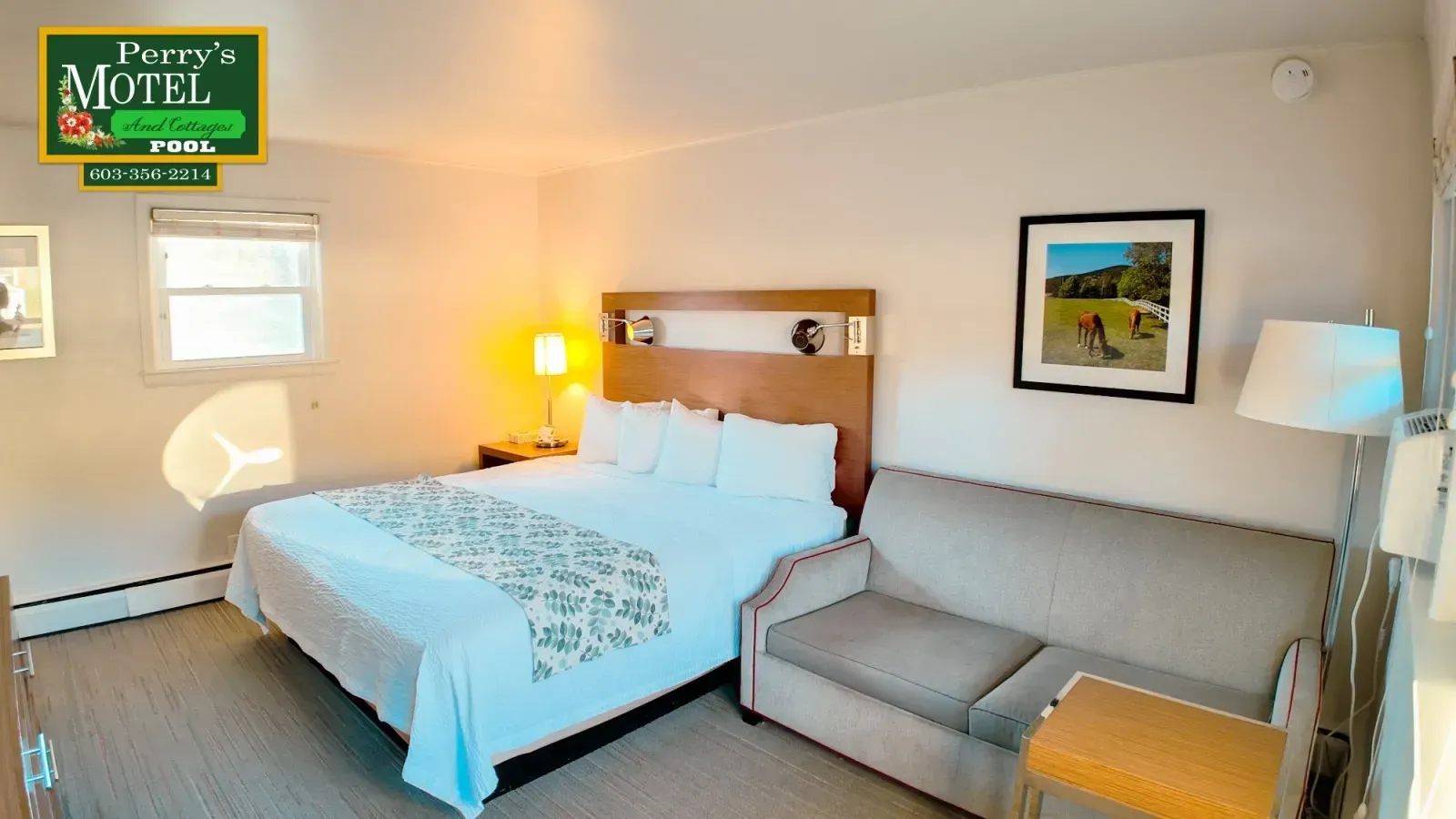 A hotel room with a king size bed and a couch.