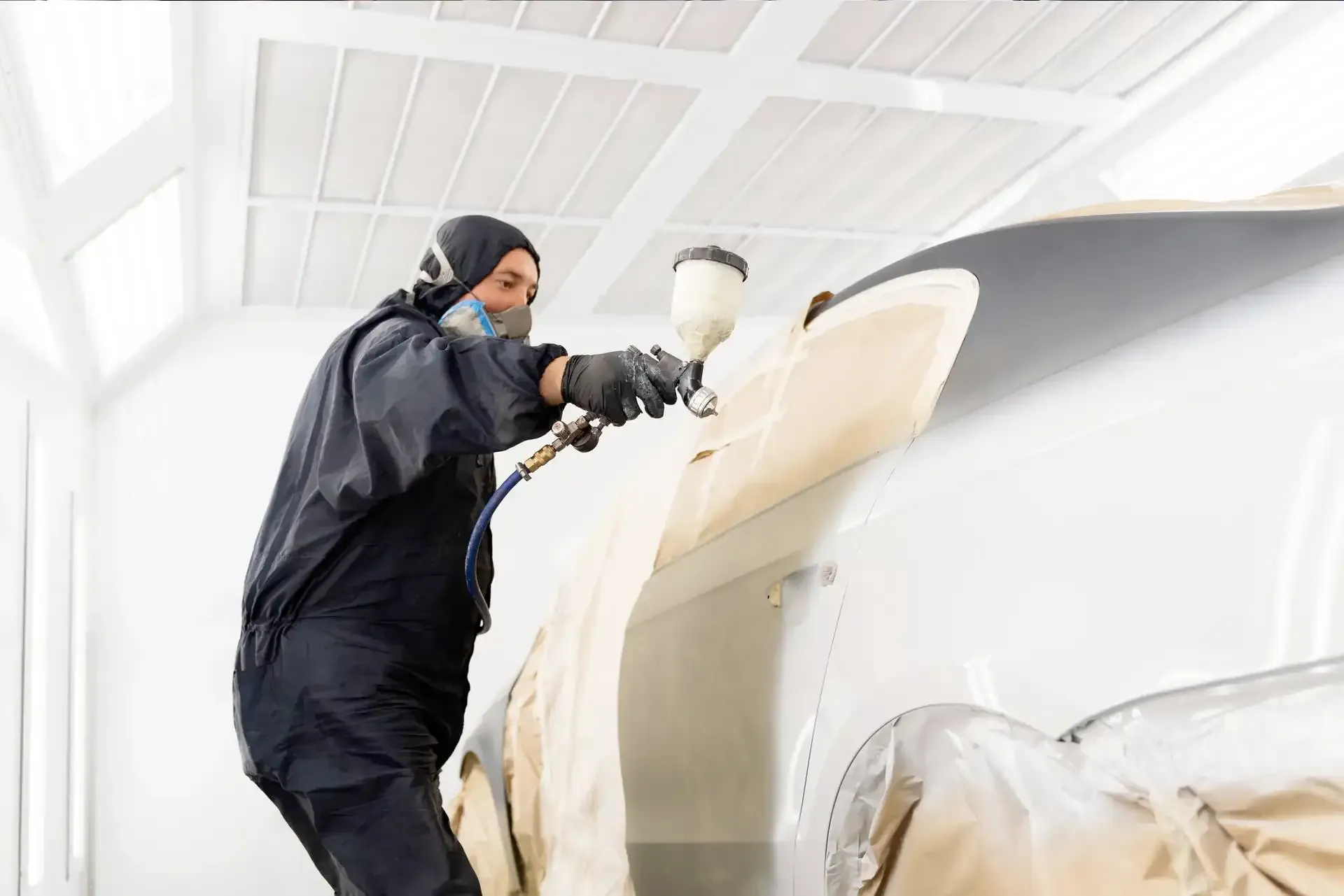 auto body shop painter spraying car