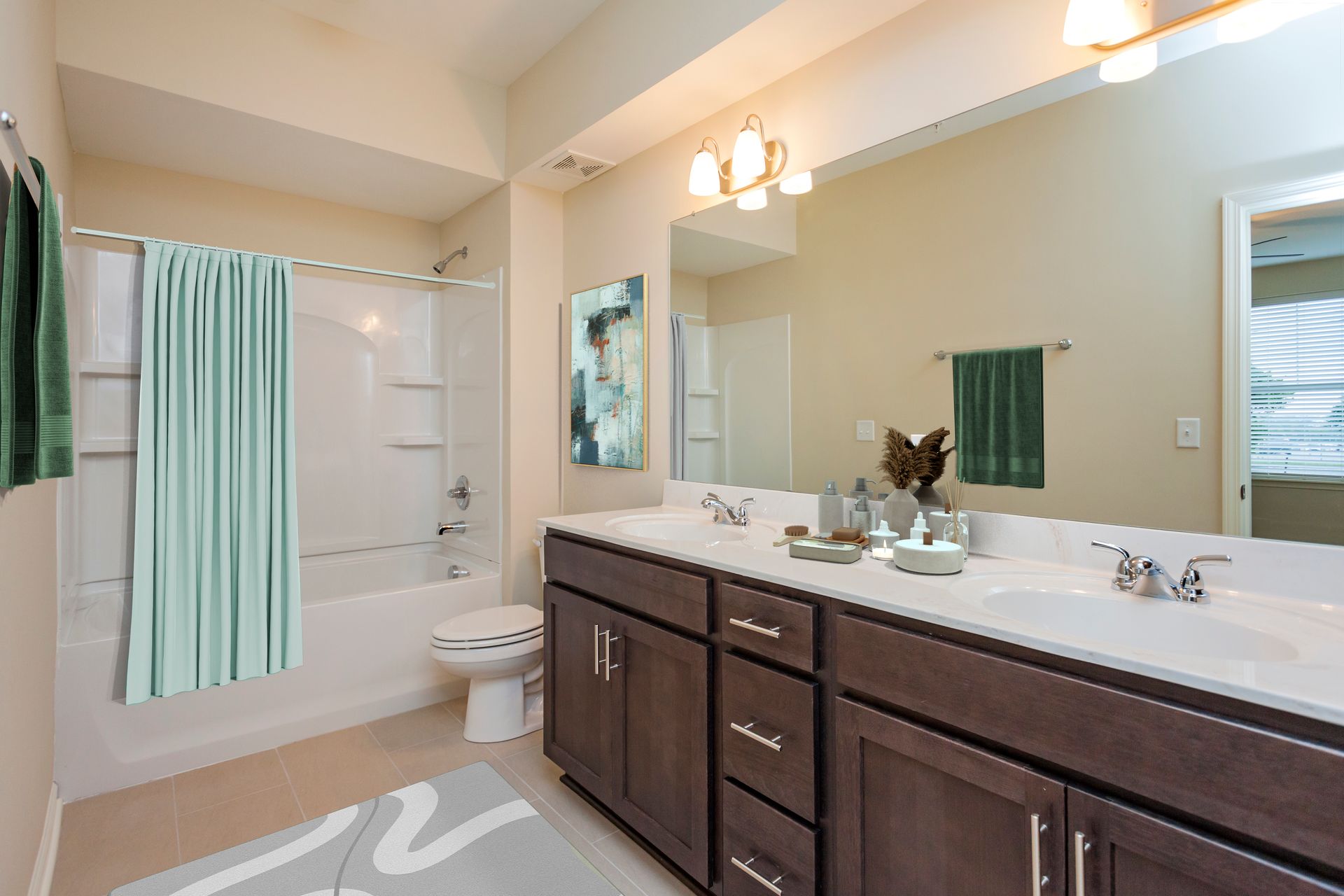 A bathroom with a dark wood double vanity, a light blue shower curtain, a white toilet, and a large mirror.
