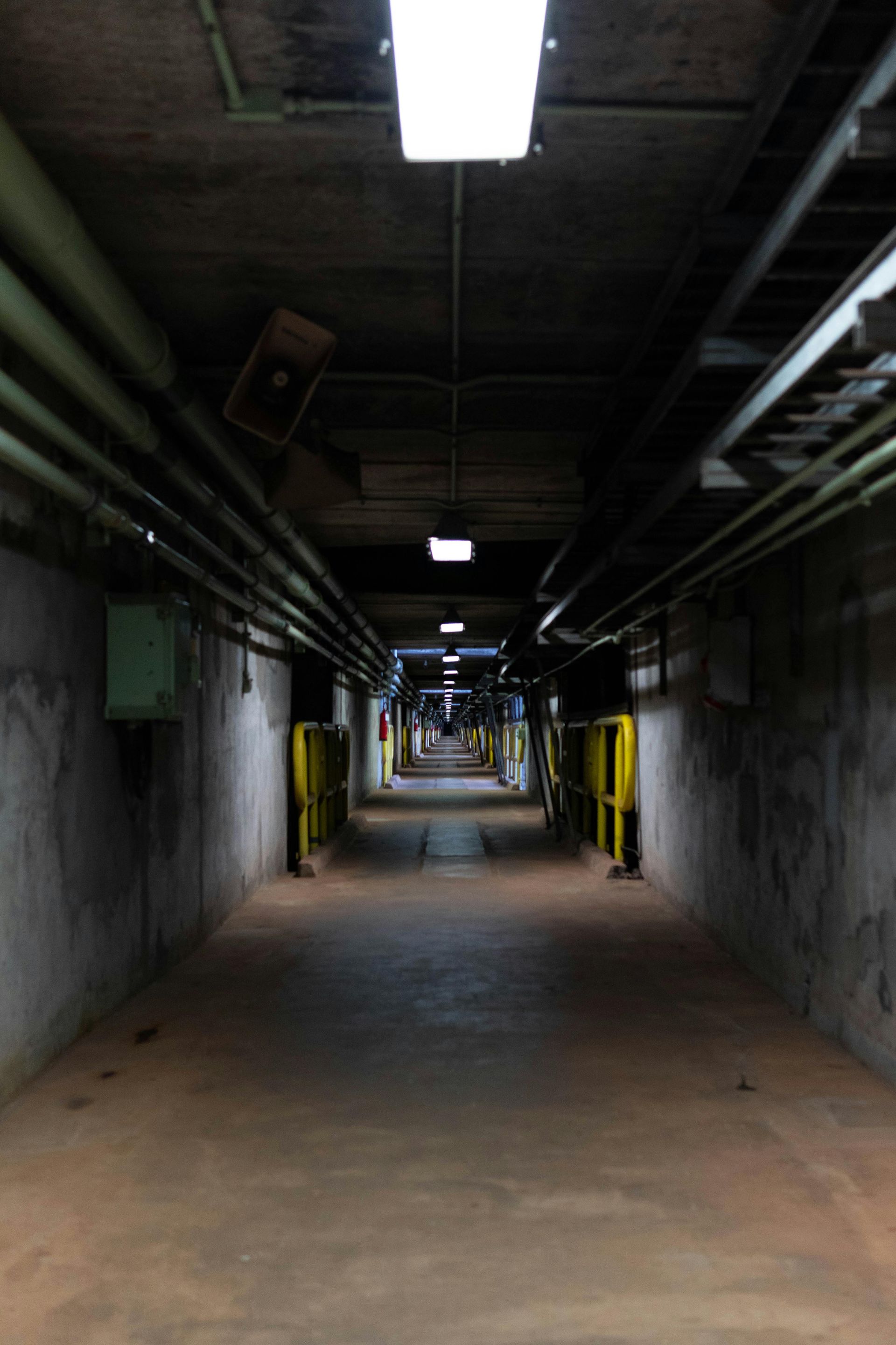 Electric vehicle charging station in parking lot, sign reads 'Charging Station Electric Vehicles Only While Charging.'
