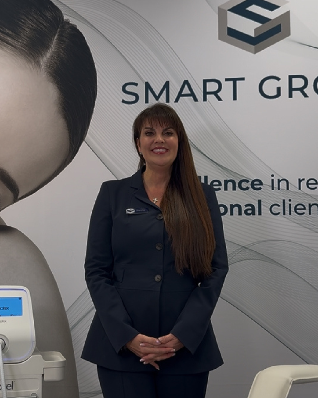 A woman stands in front of a smart group sign