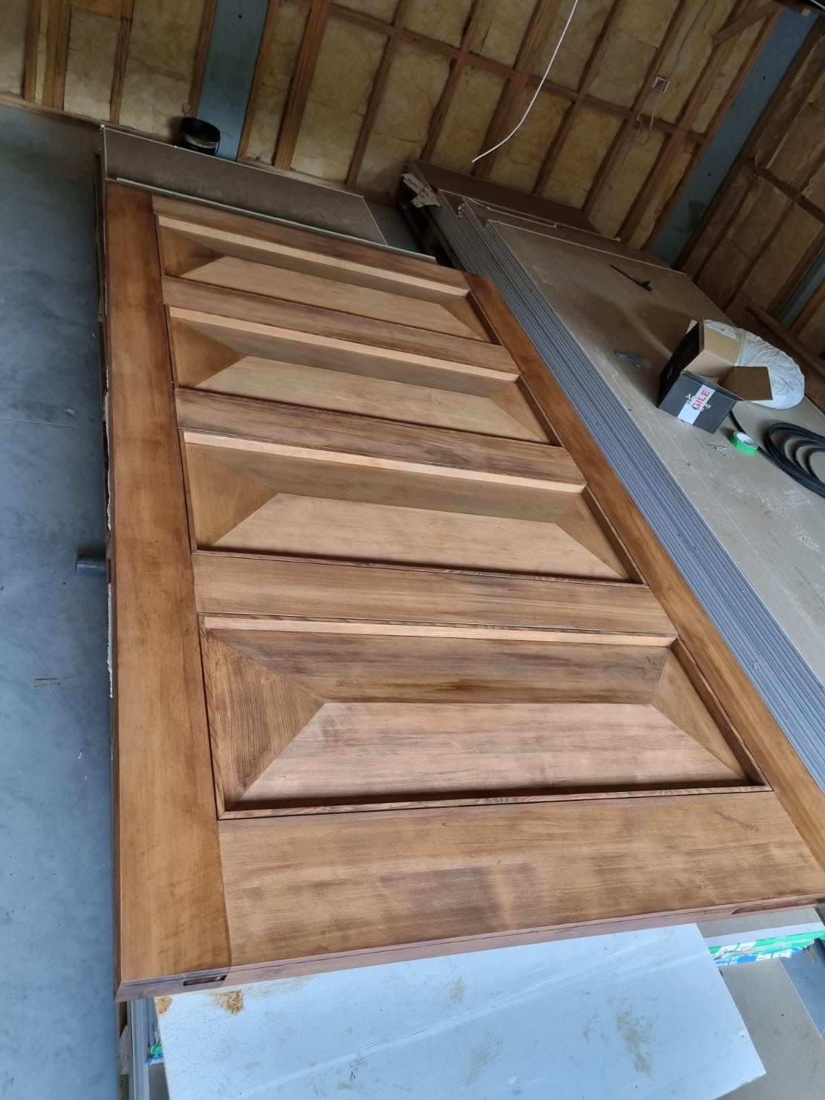 A wooden door is sitting on top of a table in a room.