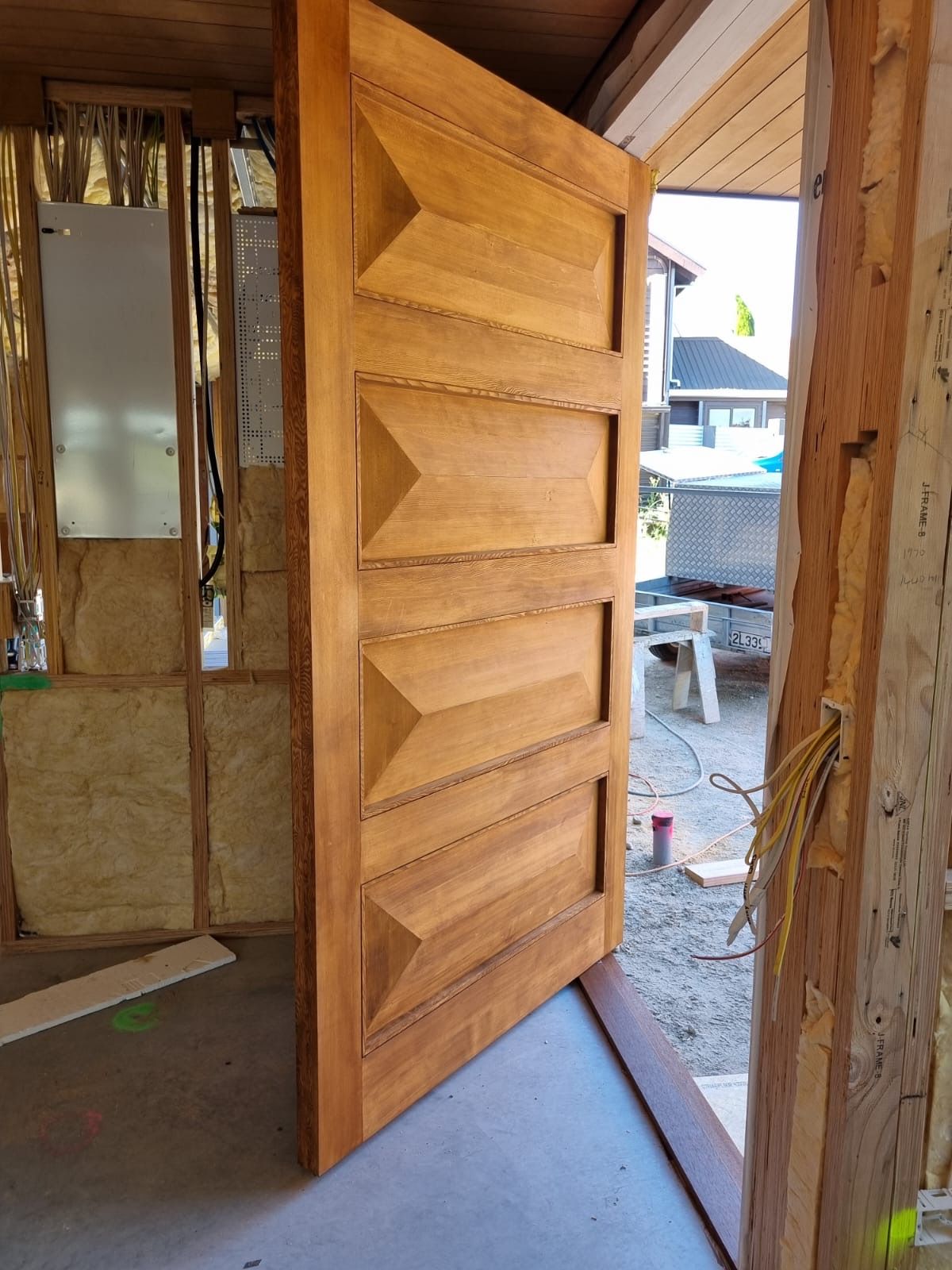 A wooden door is open in a building under construction
