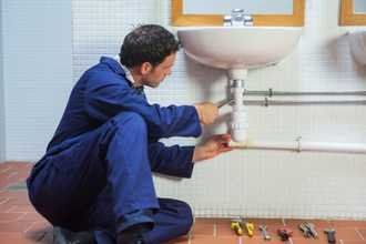 Plumber repairing sink - Plumbing contractor in Burlington, VT
