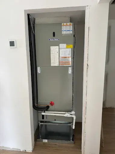 An air conditioner is installed in a closet in a house.