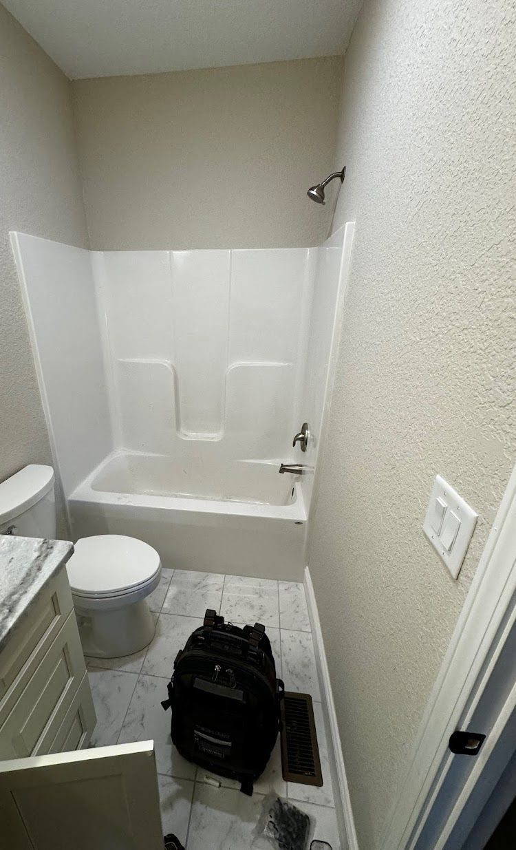 Prestige Plumbing LLC- a bathroom with a tub , toilet , sink and shower.
