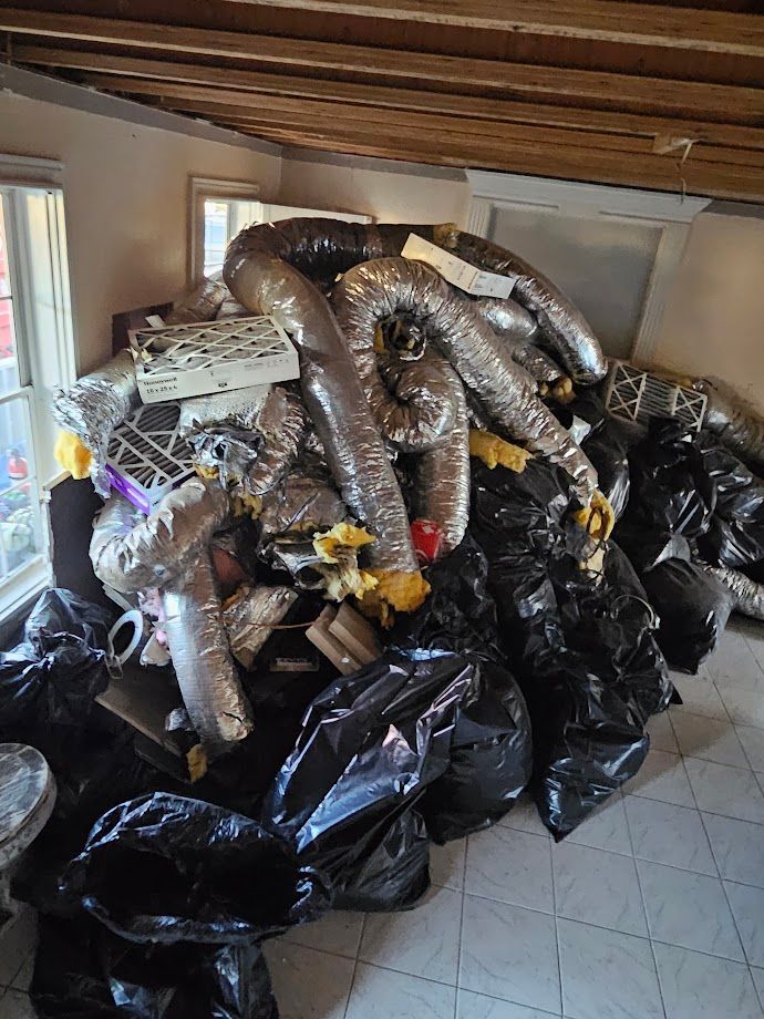 A pile of garbage is sitting on the floor in a room.