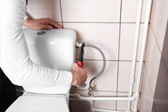 Plumber Fixing Toilet — Plumbing in Hervey Bey, QLD