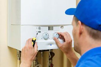 Plumber Fixing Thermostat — Plumbing in Hervey Bey, QLD