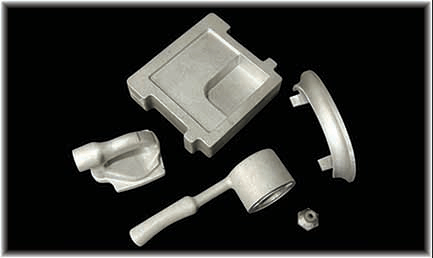 A group of metal parts are sitting on top of each other on a black surface.