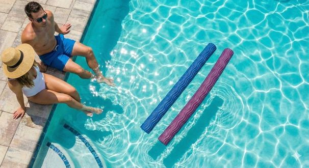 Two people sit by a pool with blue and pink lane noodles floating in clear water.
