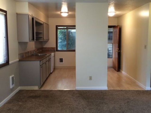 living room with view of kitchen and front entryway