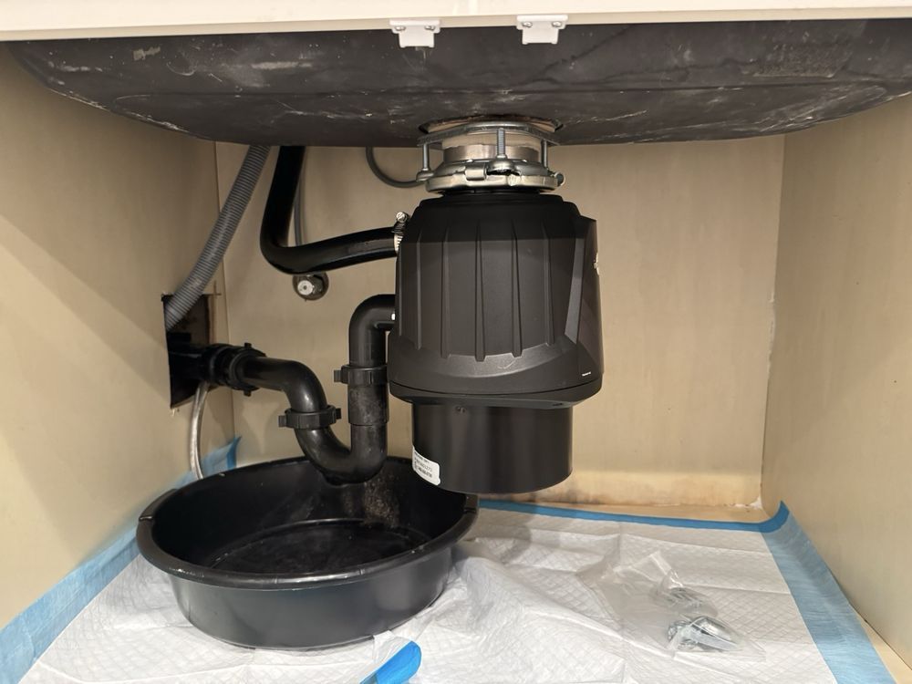 newly installed under-sink garbage disposal with updated plumbing connections in Orange, CA