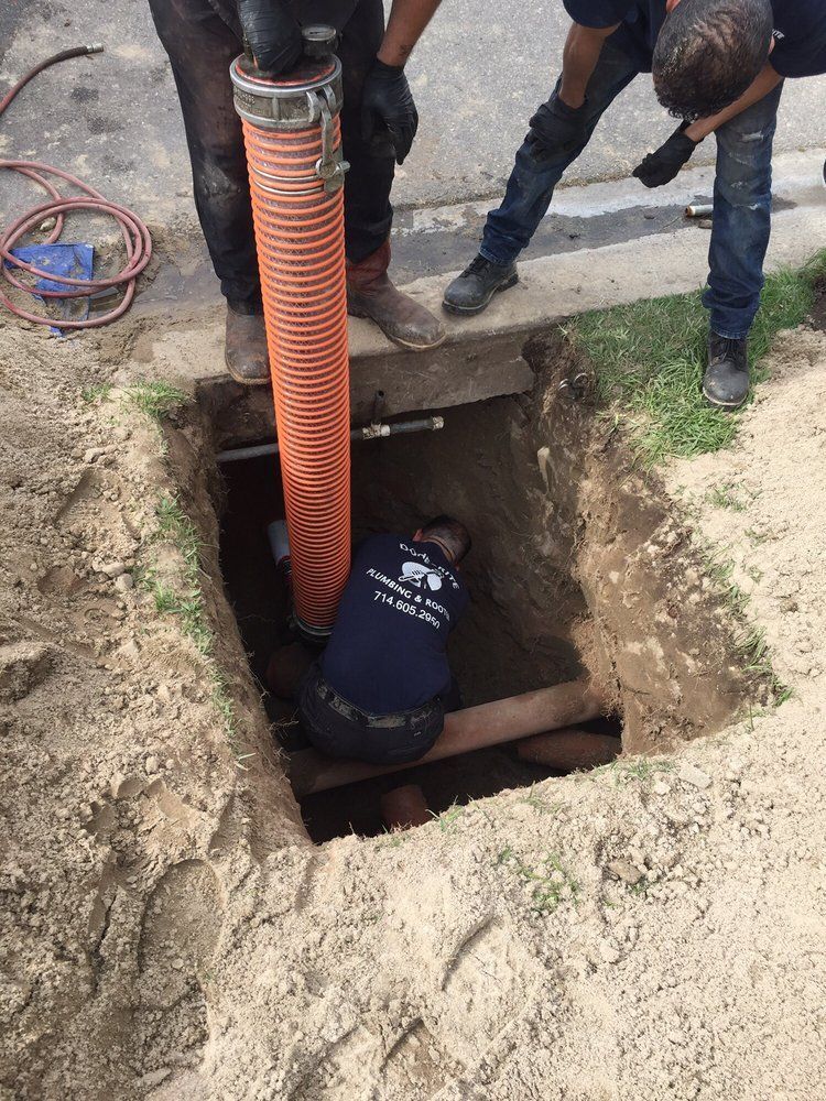 Sewer Line Repair Orange, CA 2 – plumbers working in trench performing underground sewer line repair with exposed piping