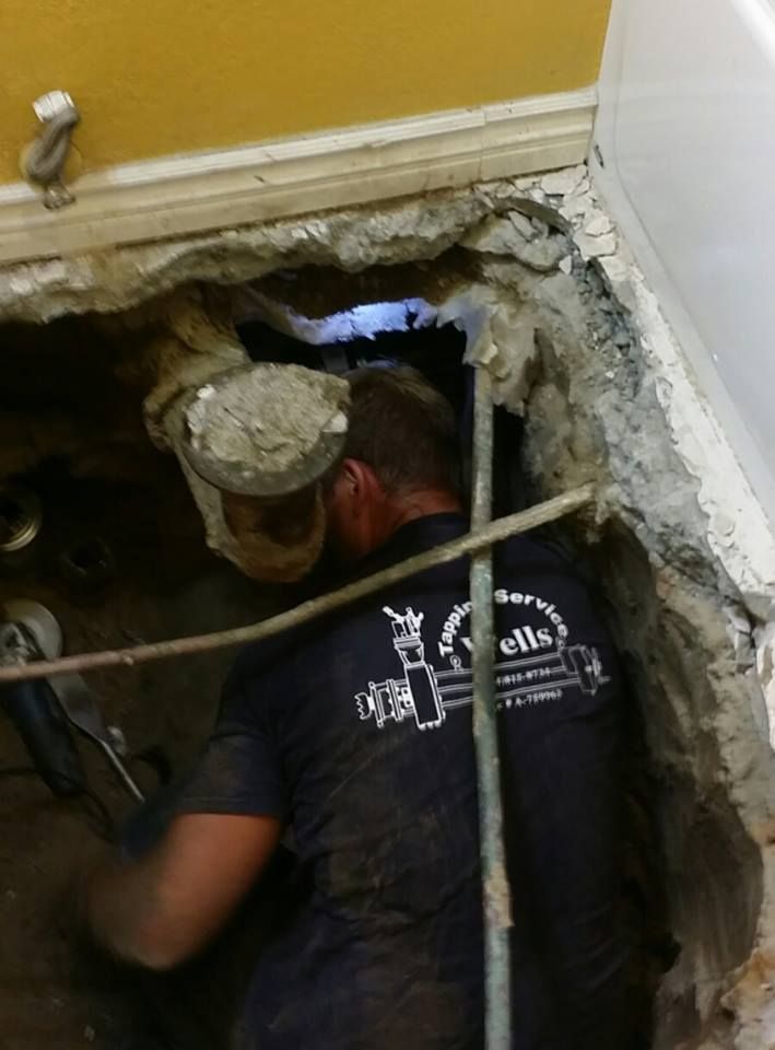Signs of Hidden Water Leaks in Orange, CA Homes – Plumber repairing pipes beneath a concrete floor.