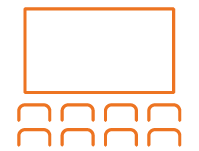 A row of seats in front of a large screen.