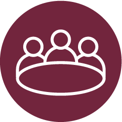 Three people around a table in a burgundy circle.