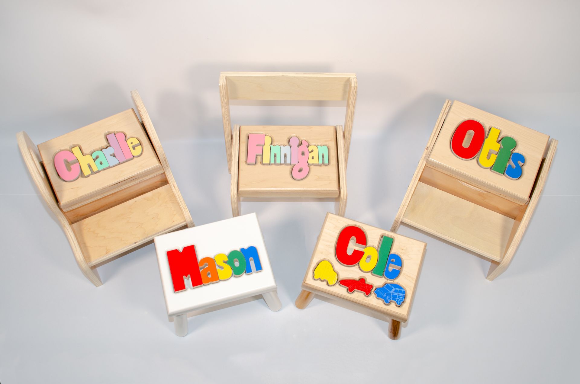 Colorful name blocks on small wooden stands arranged on a light background