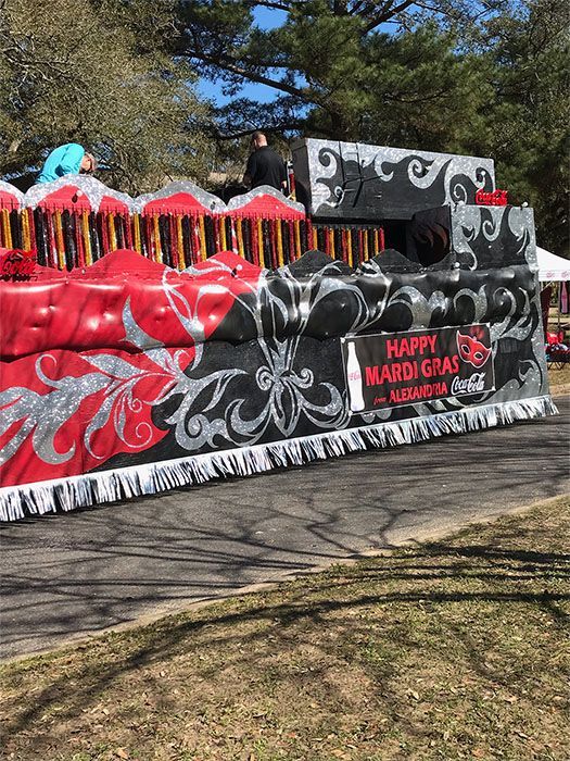 Mardi Gras parade float with red, black, and silver decorations; 