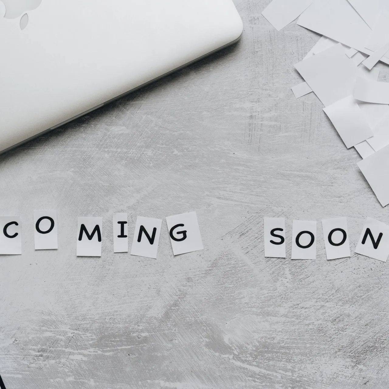 the word coming soon is written on a piece of paper