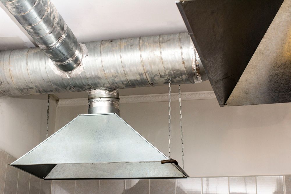 Metal kitchen exhaust hood with dripping condensation near ductwork — Central Coast Commercial Kitchen Cleaning in Terrigal, NSW