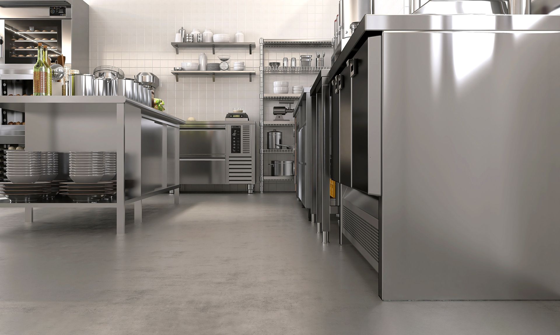 A commercial kitchen with stainless steel appliances, shelving, and concrete floor — Central Coast Commercial Kitchen Cleaning in Swansea, NSW