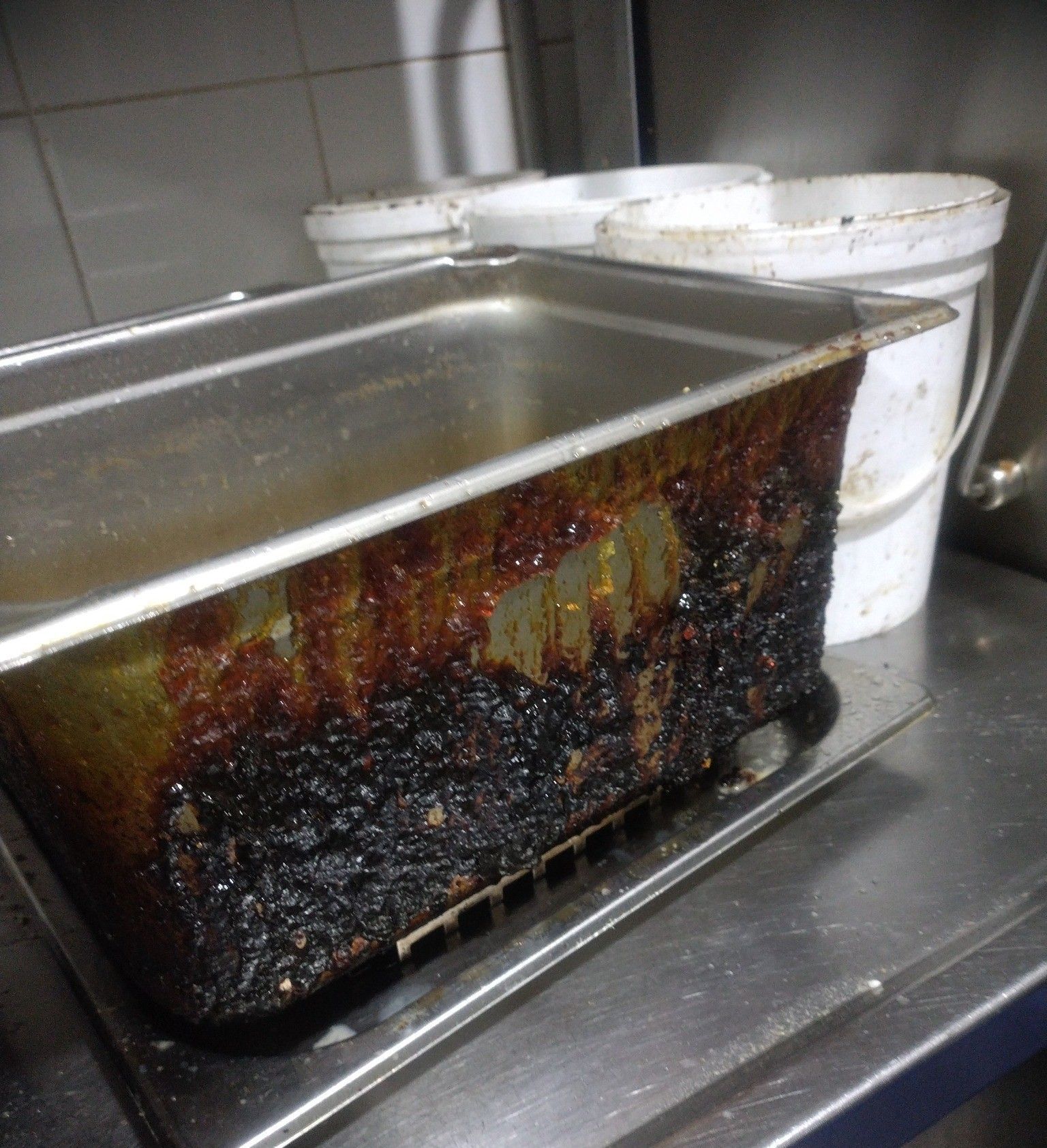 Metal Food Pan With Caked-on, Burnt — Central Coast Commercial Kitchen Cleaning in Gosford, NSW