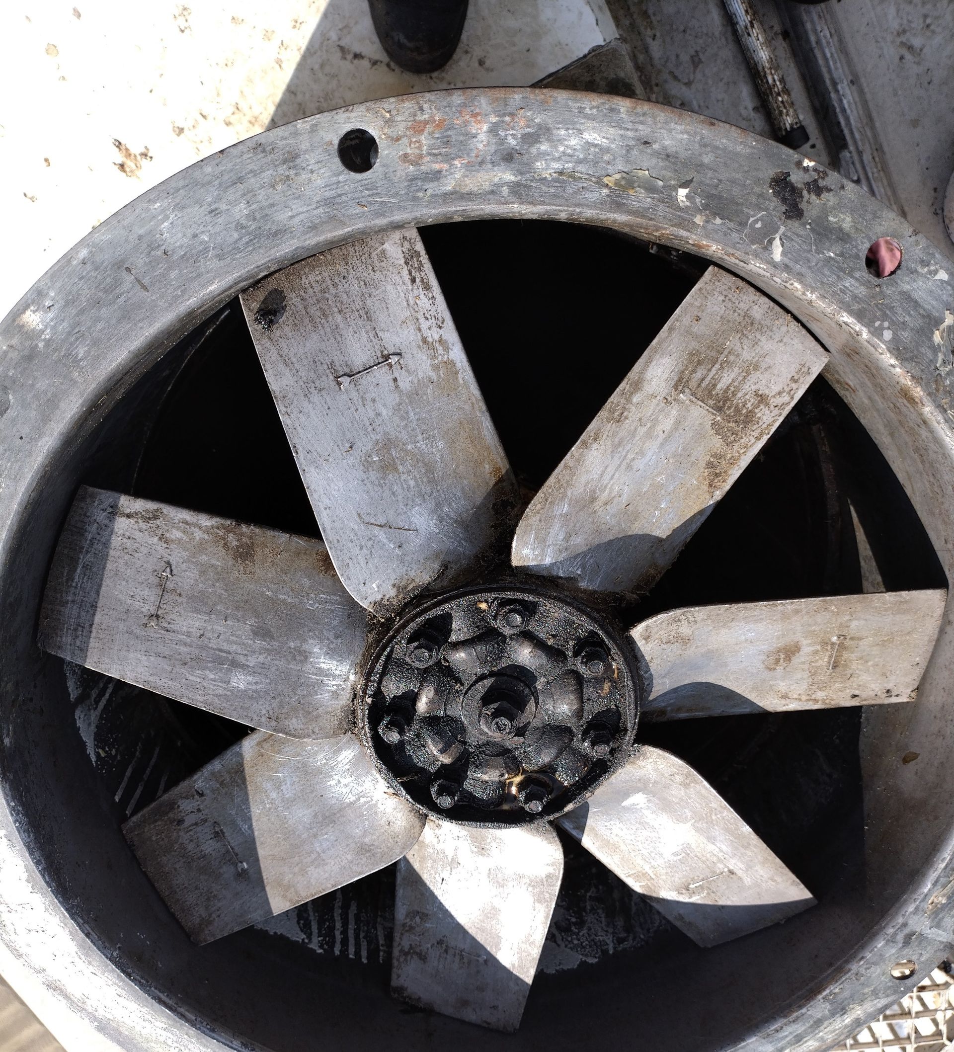 Close-up of a metal fan with eight blades inside a circular frame; black residue on the central hub — Central Coast Commercial Kitchen Cleaning in Newcastle, NSW