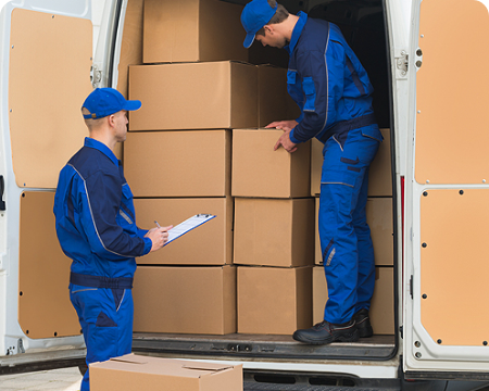 Two delivery men are loading boxes into a van.