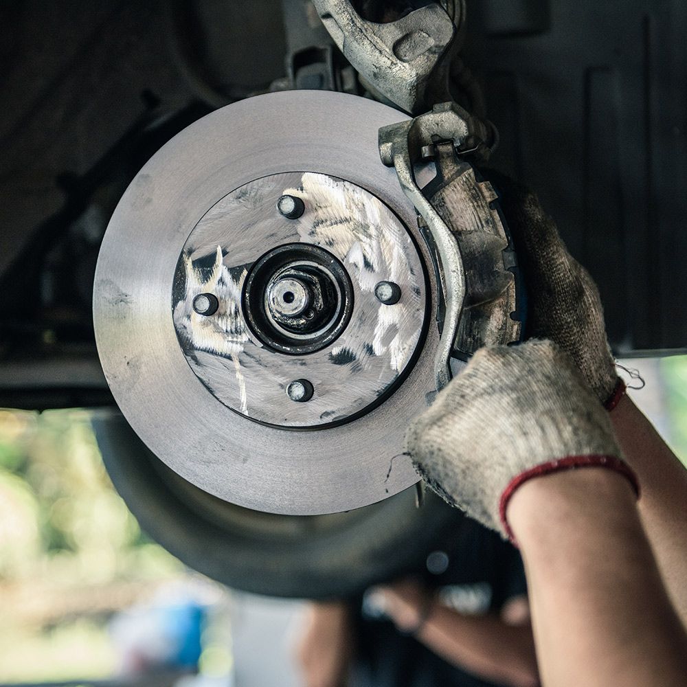 Worn brake rotor and brake pads during brake repair service in Fort Walton Beach, FL at Trib’s Auto 