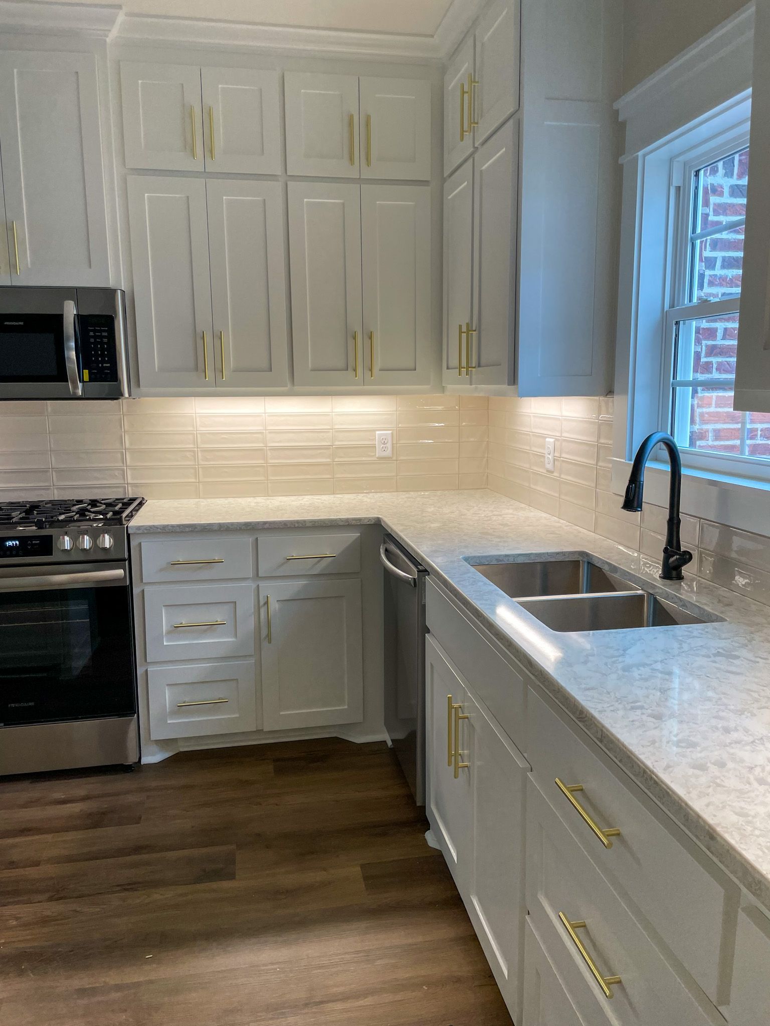 New kitchen with white cabinets and gold handles