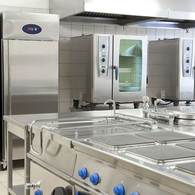 Bathroom with gray wood-look wall, pedestal sink, toilet, mirror, towel rack, wall sconces, artwork, and dark floor.