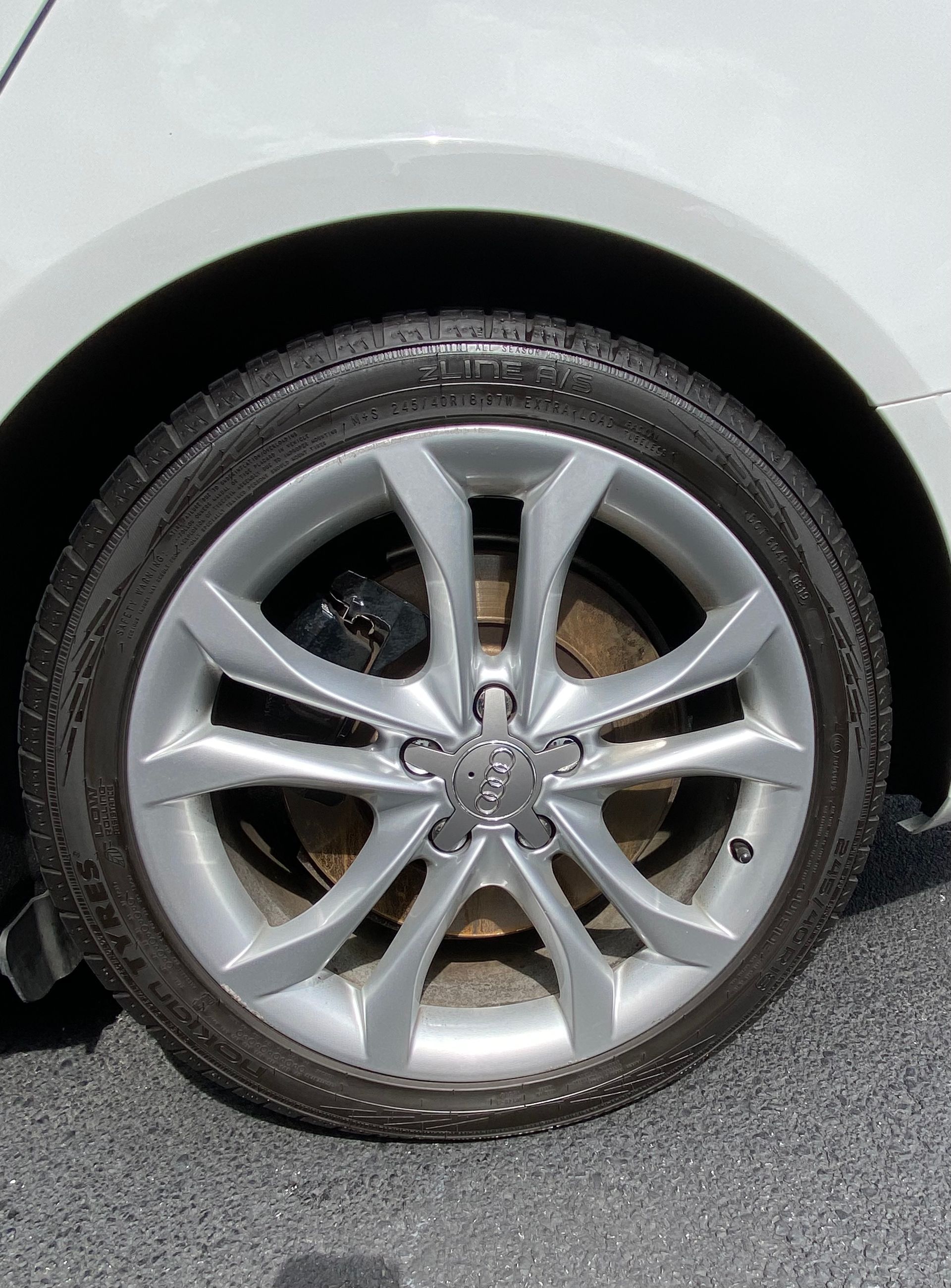 A close up of a car wheel with a tire on it