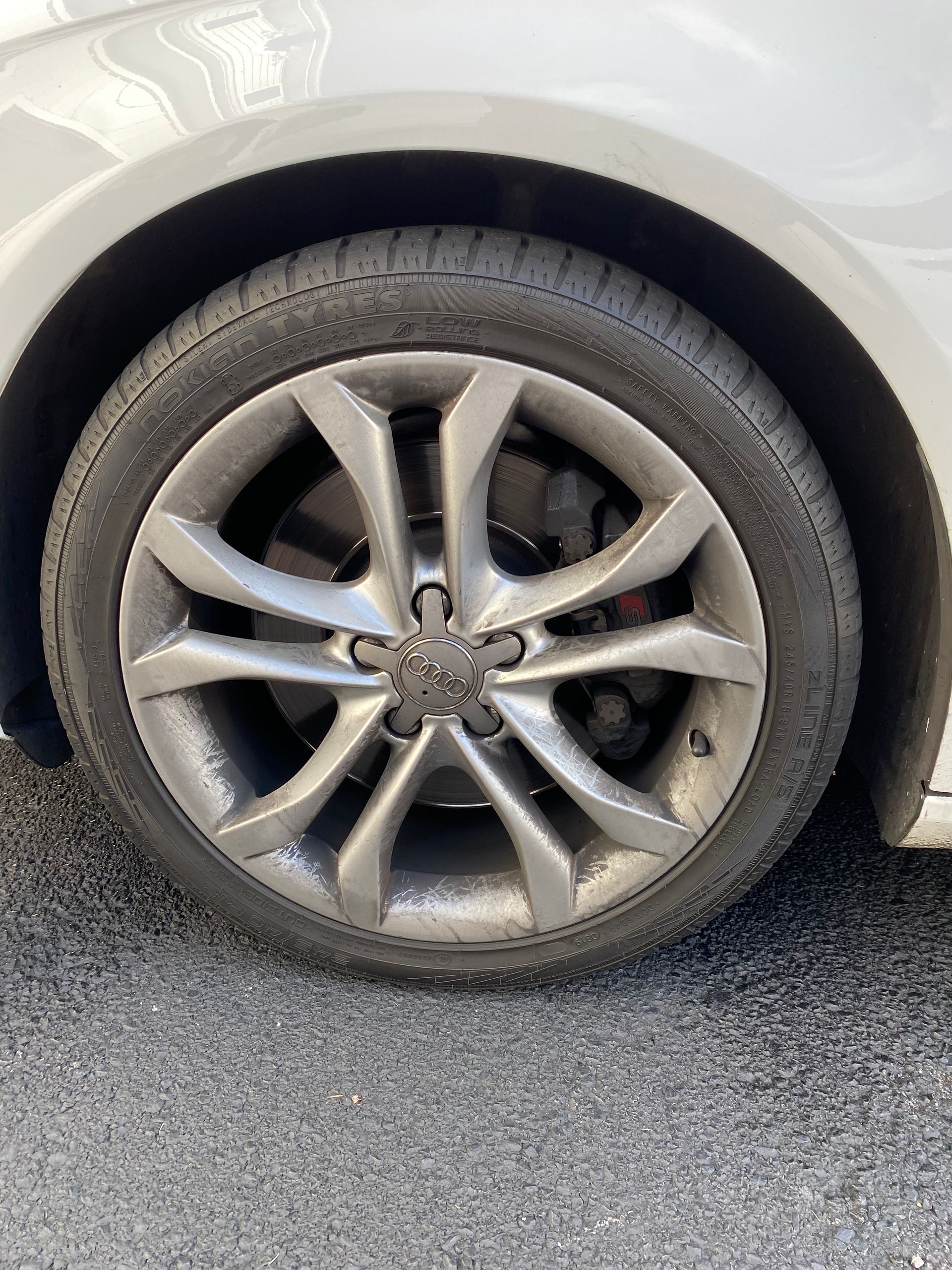 A close up of a car wheel with a tire on it.