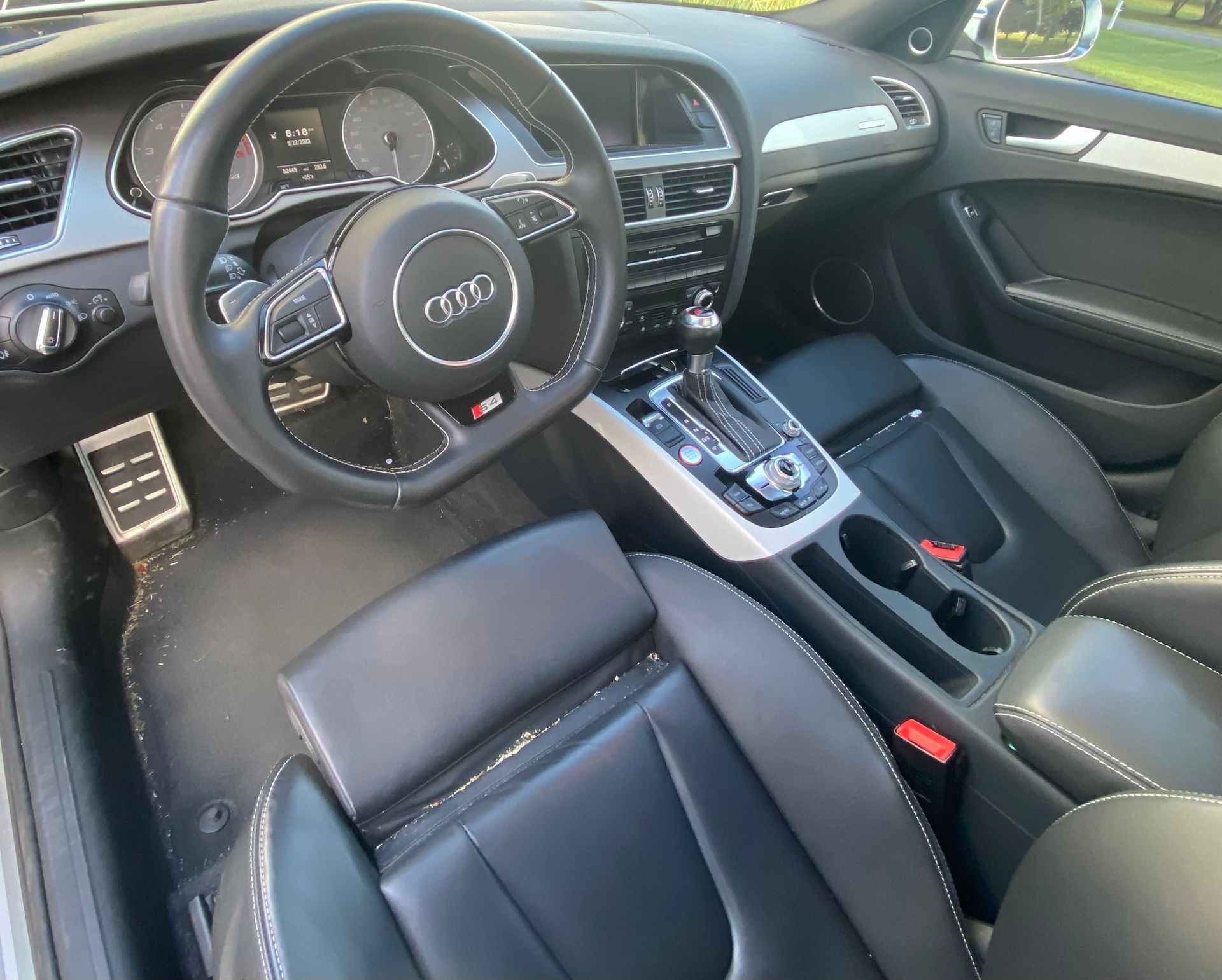 The interior of an audi a4 with black seats and a steering wheel
