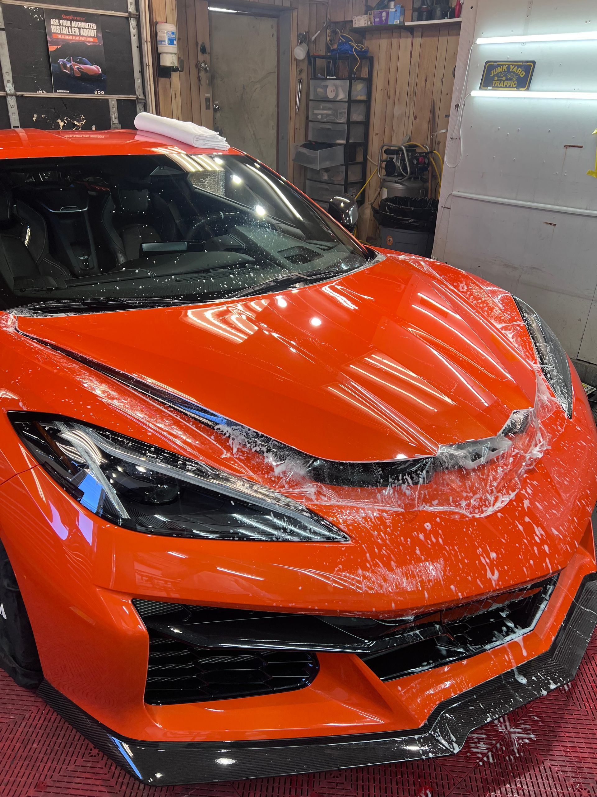 A red sports car is parked in a garage.