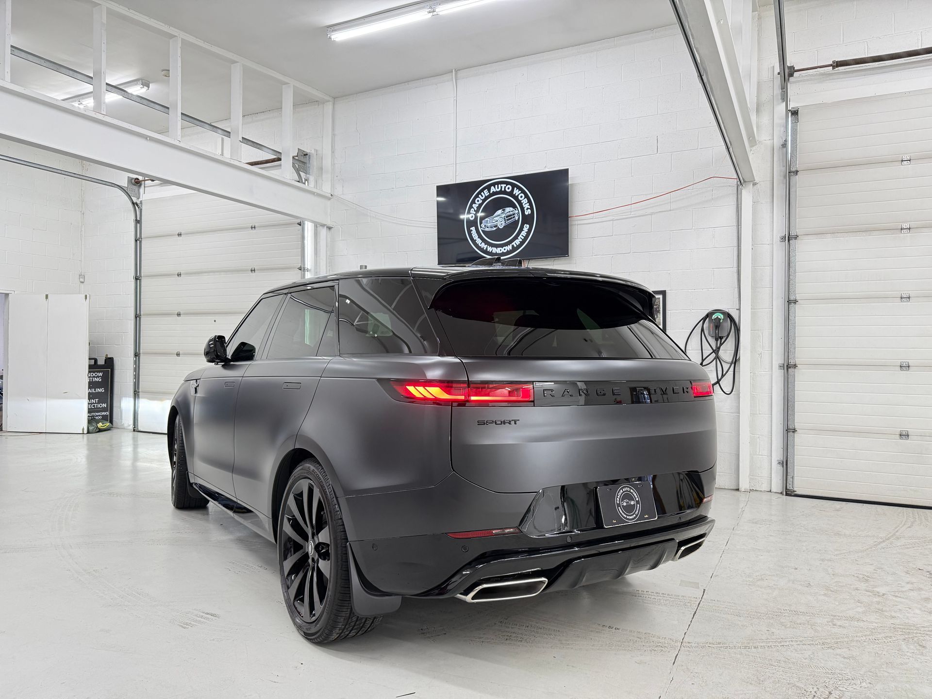 A black range rover velar is parked in a garage.