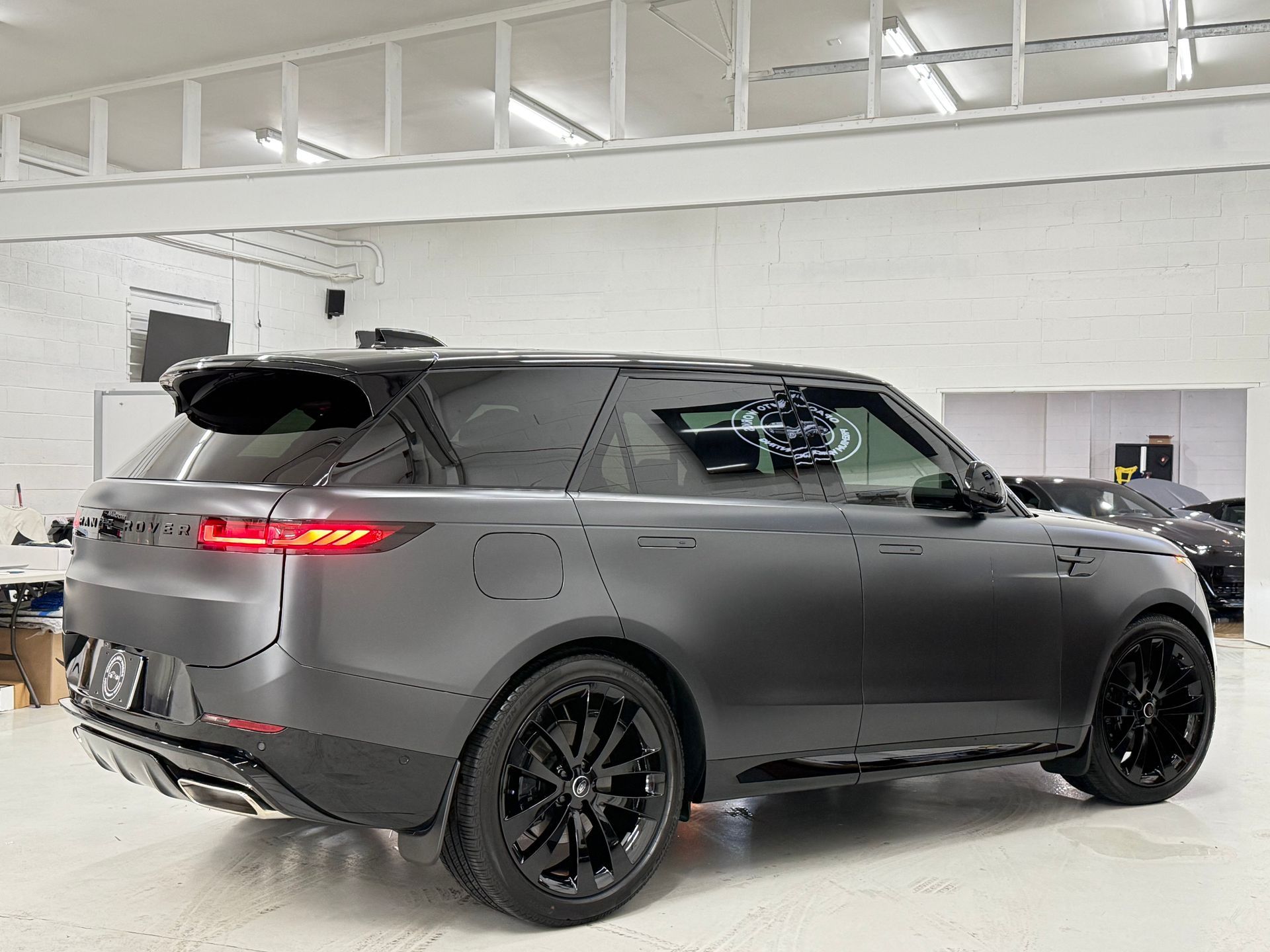 A black range rover velar is parked in a garage.