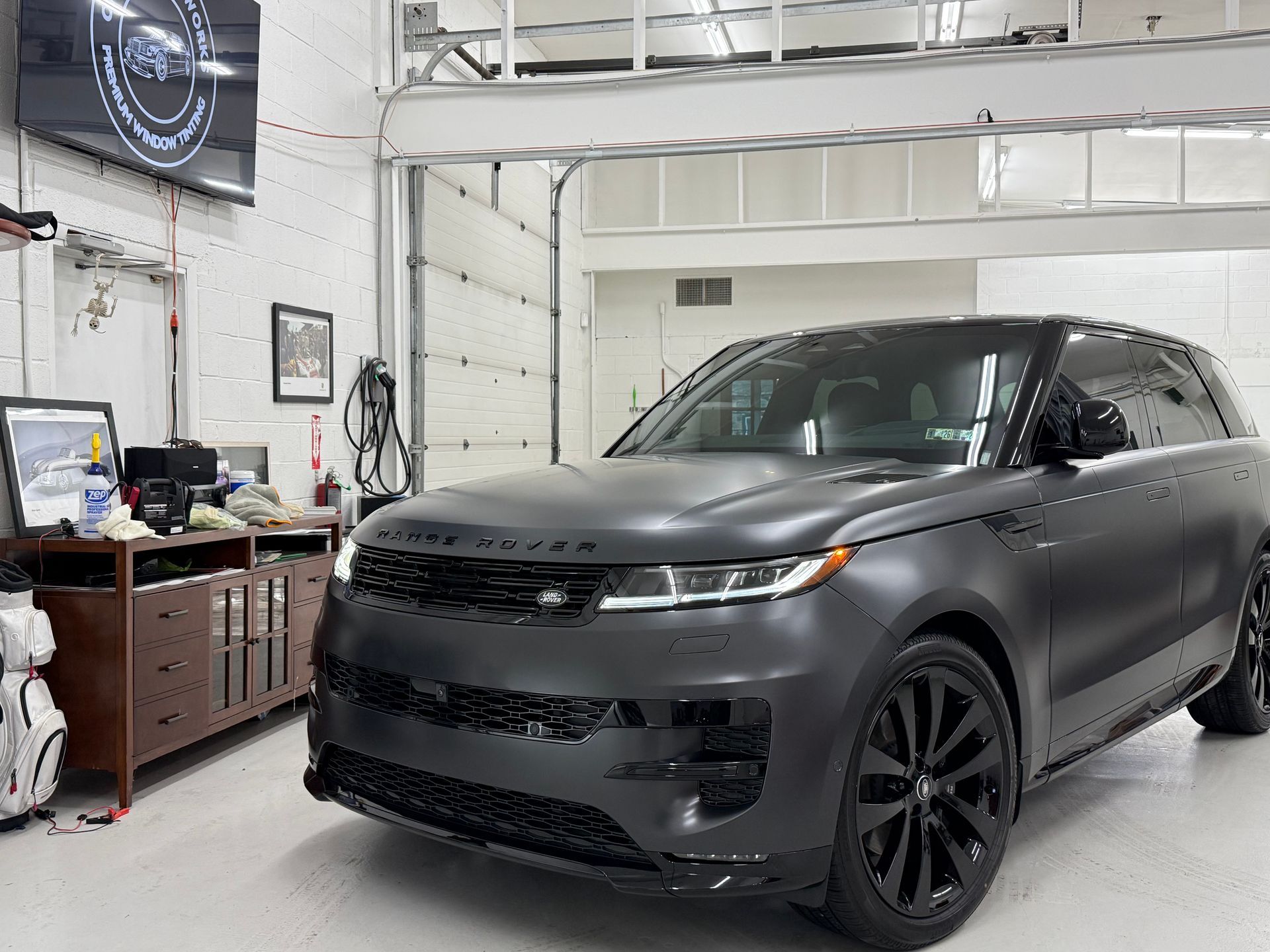 A black range rover velar is parked in a garage.