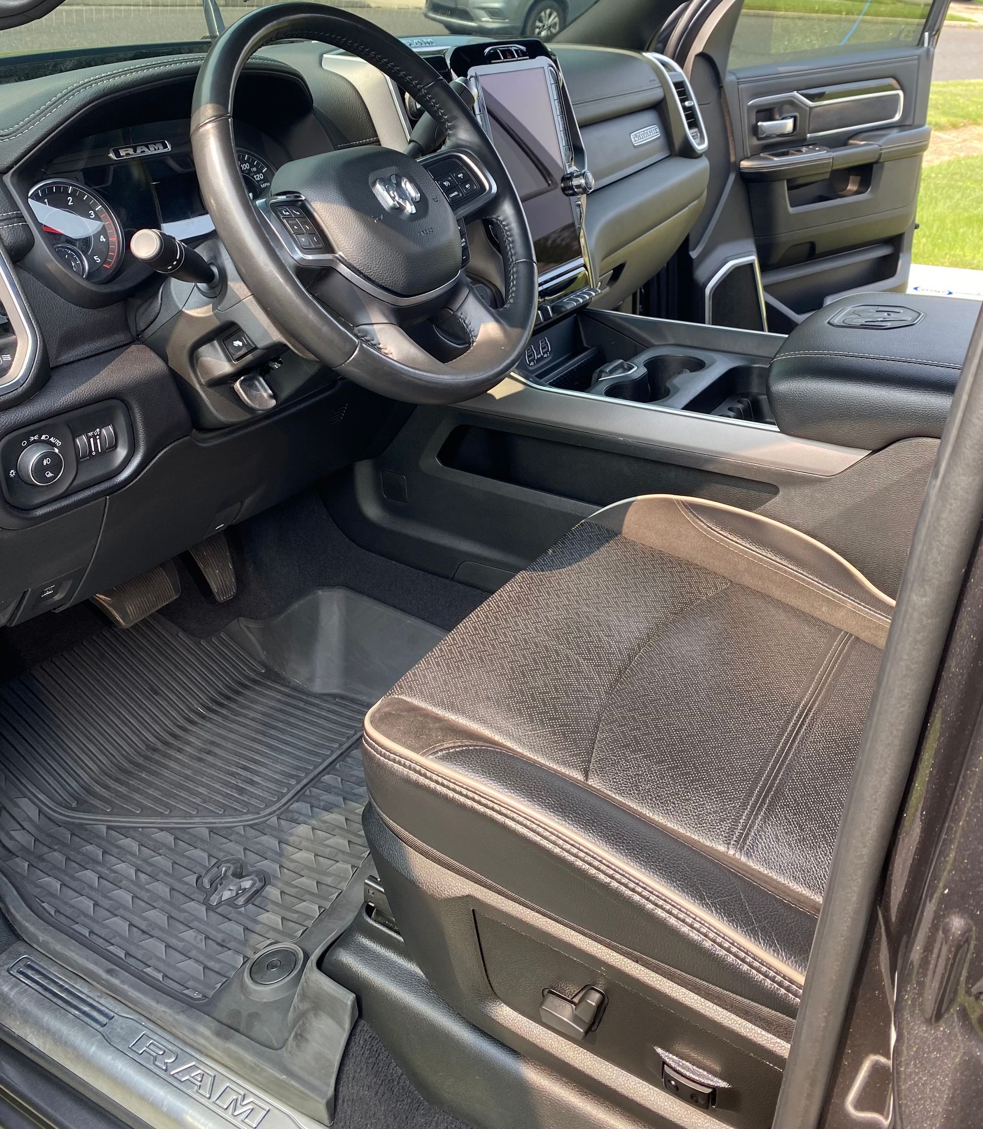 The interior of a dirty car with a steering wheel and seats.