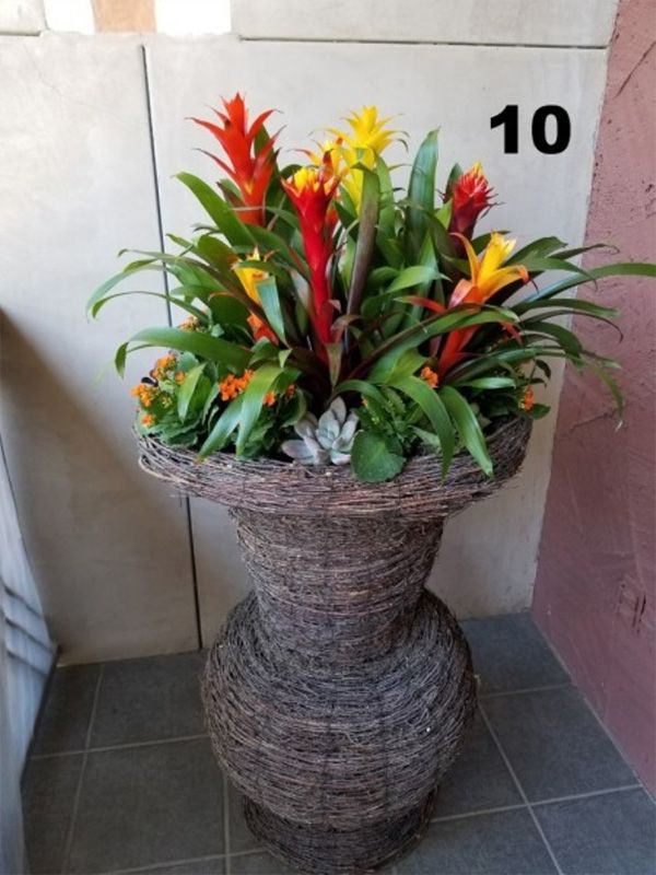A vase filled with flowers has the number 10 on it