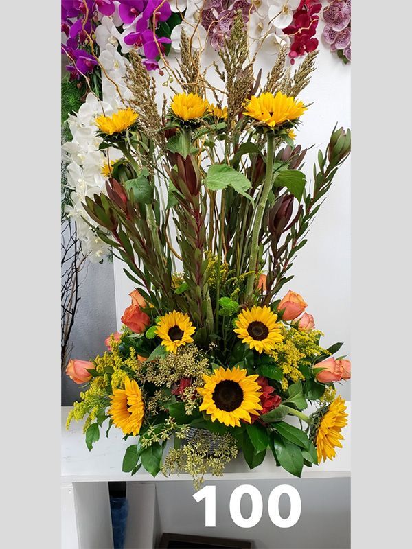 A bunch of flowers in a vase with the number 100 on it