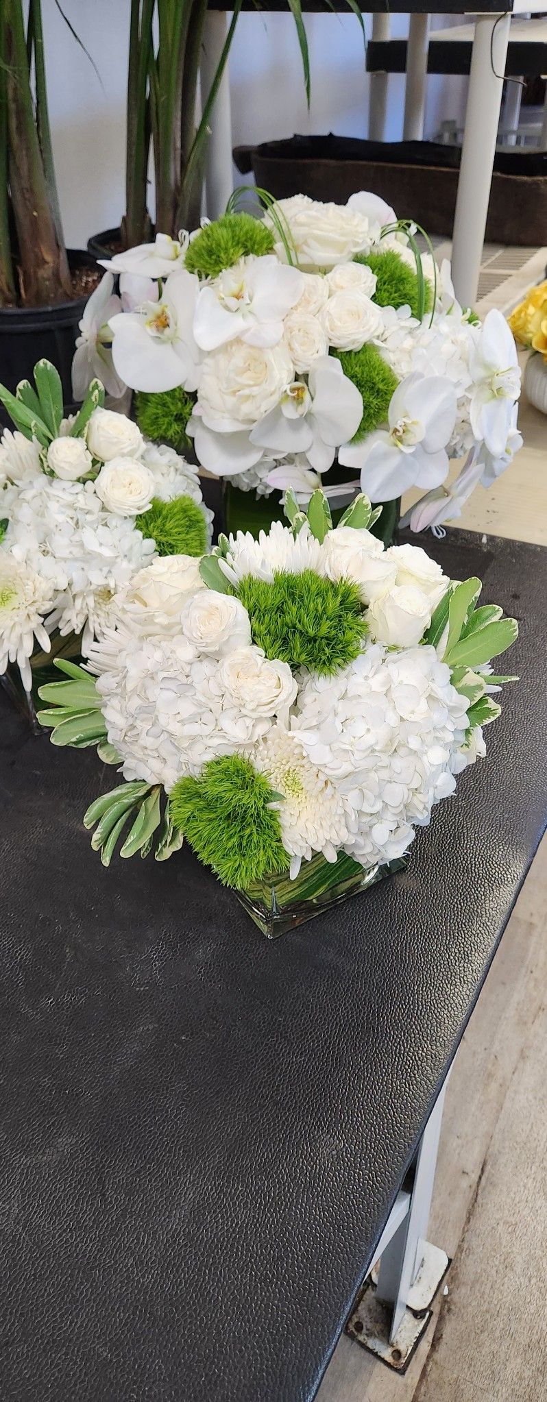 A bunch of white and green flowers are sitting on a table.